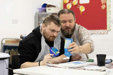 Two people painting