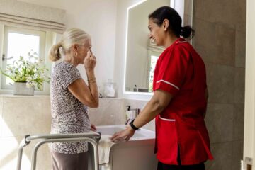 ECL customer and Community Care Assistant getting ready for bed