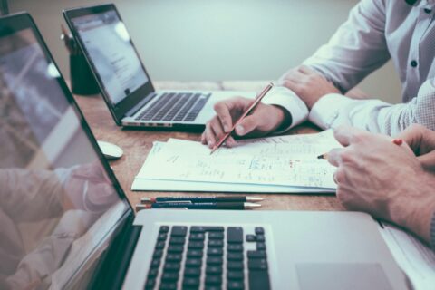 Two people overlooking training documents