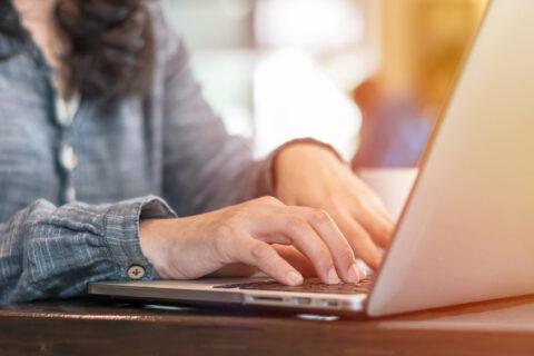 Typing on a laptop