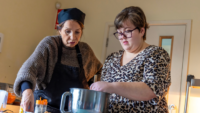 Melanie and cafe worker making a drink